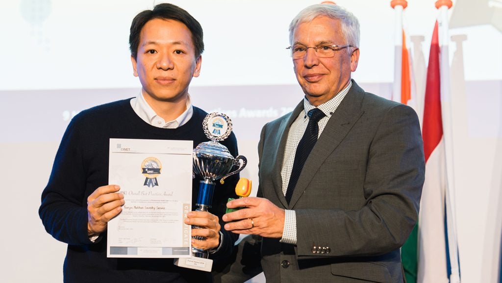 Mr.-Peter-Wennekes-CEO-of-CINET-congratulates-Mr.-Lei-Pai-of-Tianjin-Matilian-Laundry-Services-China-with-his-Overall-Award-2024-Category-ITS.jpg
