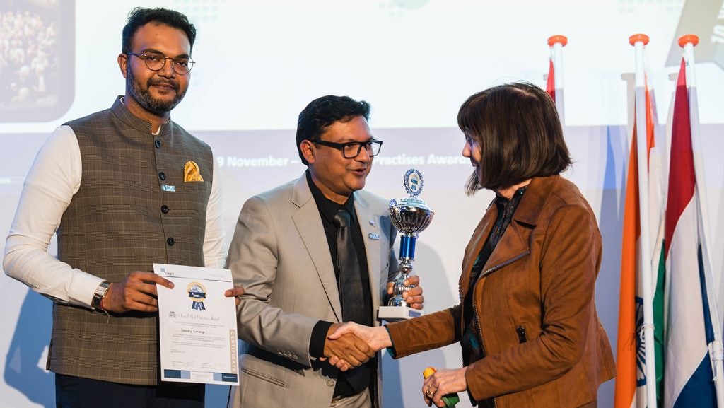 Mrs.-Jan-Barlow-Country-Coordinator-USA-congratulates-Mr.-Jash-Dalal-and-Mr.-Anup-Poddar-of-The-Laundry-Concierge-India-with-their-Overall-Award-2024-Category-RTC-Sme.jpg
